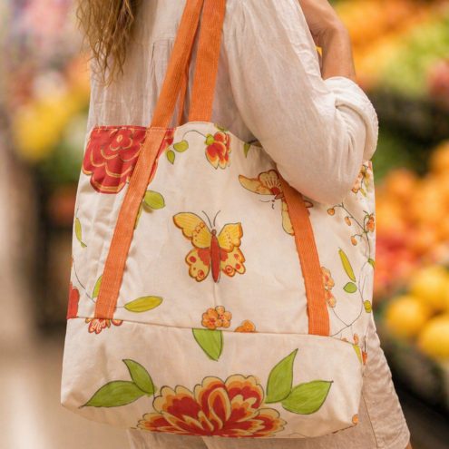 Orange butterfly tote bag - side on view
