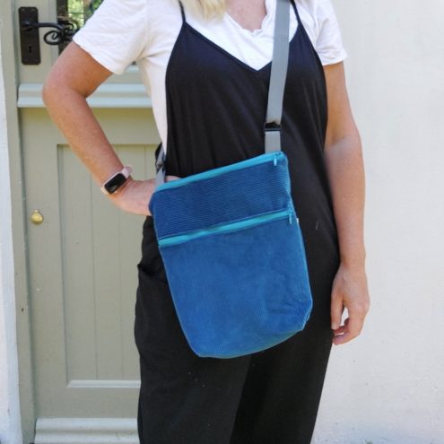 wearing the dark blue corduroy bag