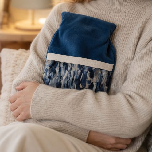 model holding blue hot water bottle