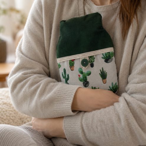 Model holding cactus hot water bottle